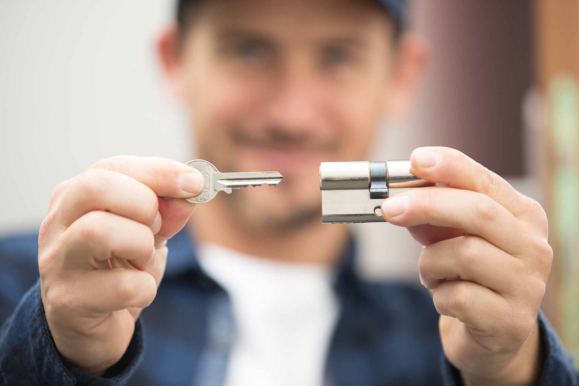 Professional locksmith in Umhlanga holding a lock cylinder and key